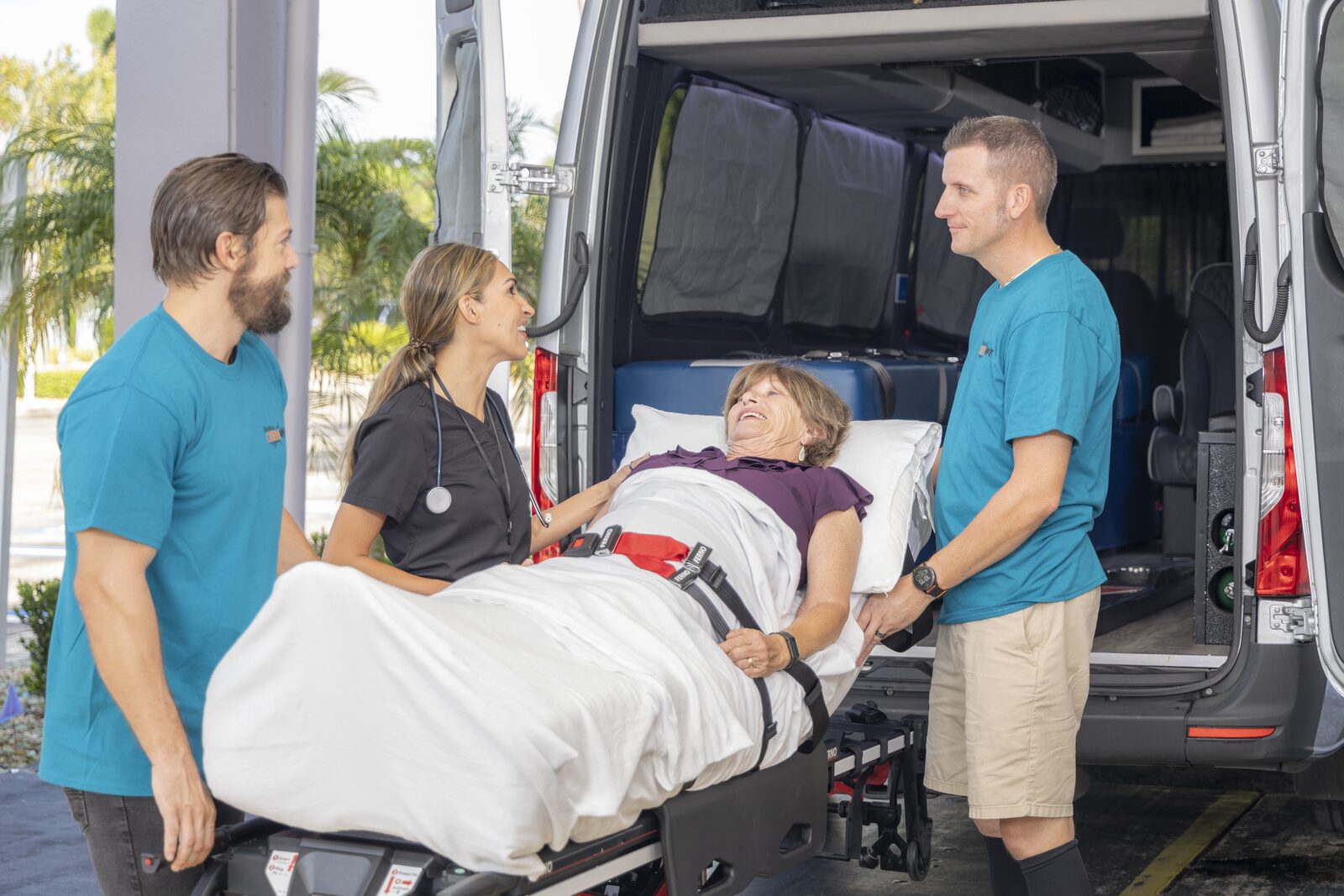 CienOne crew loading a patient into a medical transport van